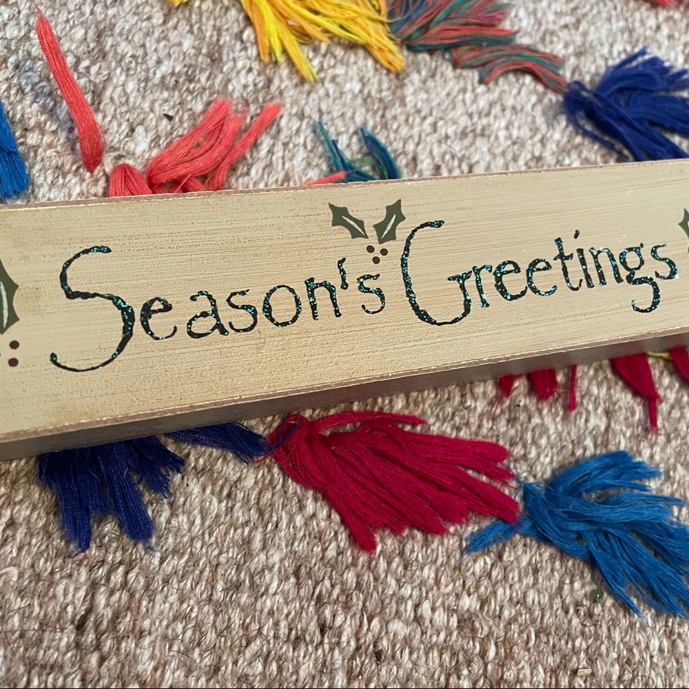 Small wooden and sparkly season’s greeting sign